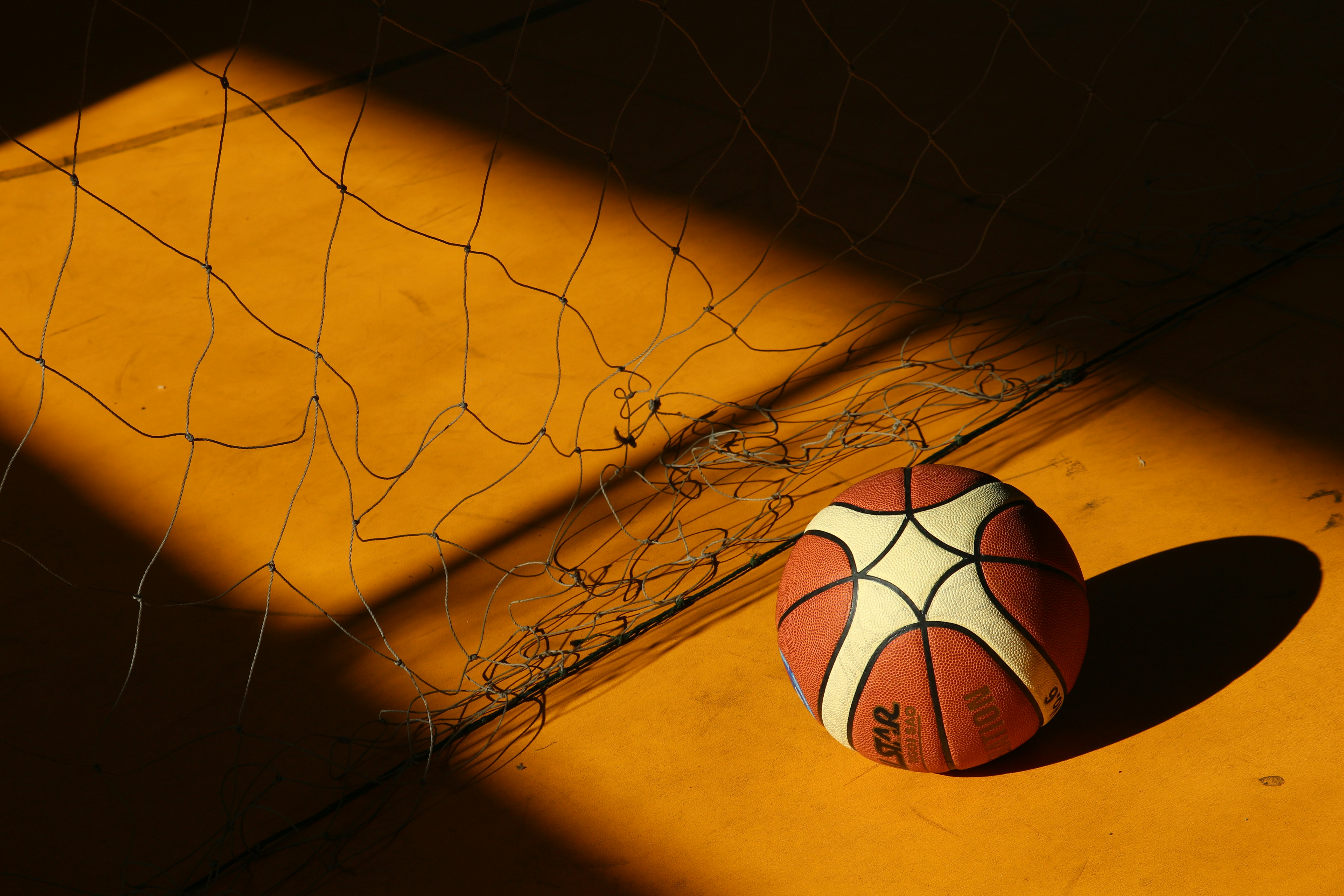 A basketball amidst the interplay of light and shadows