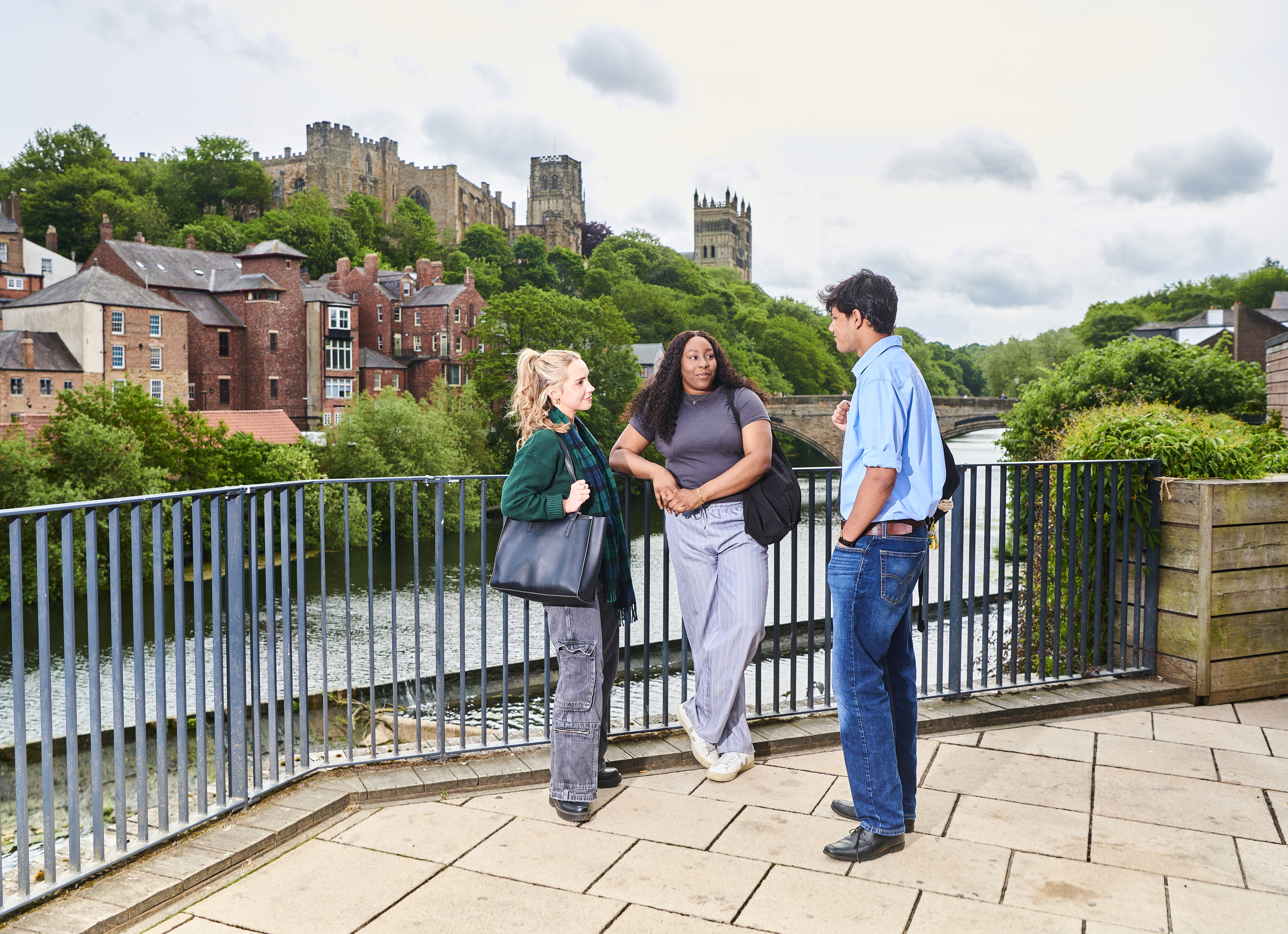 a person standing next to a fence