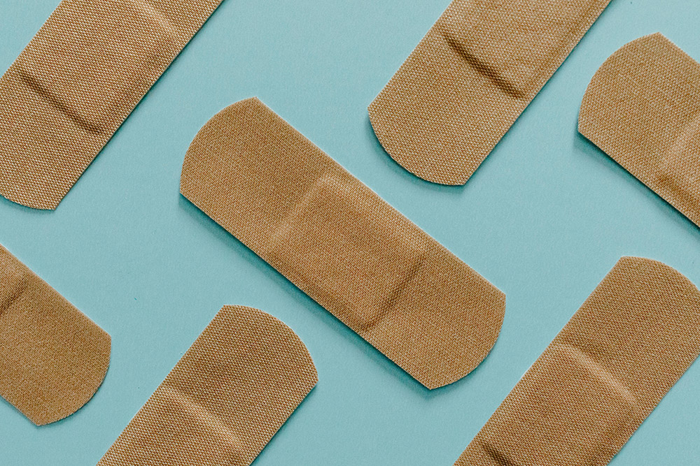 Close Up View Of Band Aids On Blue Surface