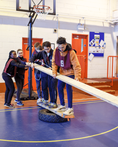 Group of students balancing holding a plank