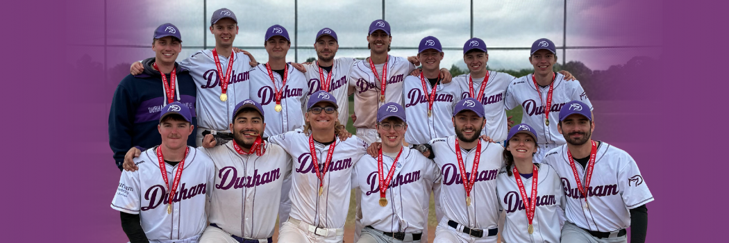 A baseball team wearing medals posing in two lines for the camera