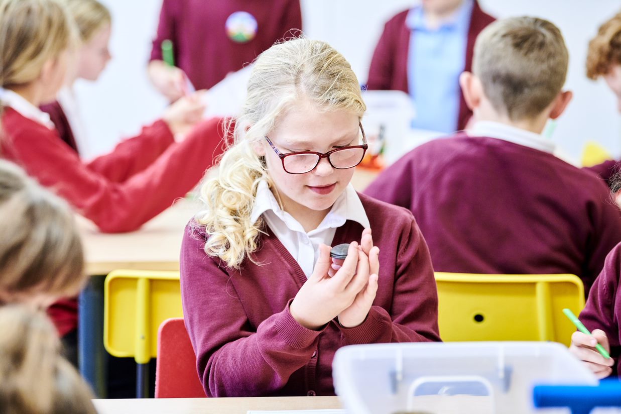 A child examining a stone