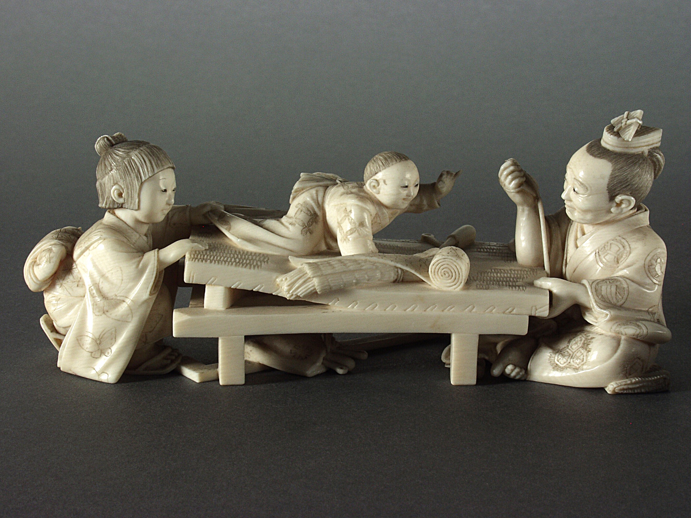 Ivory carving of a weaver and his family, dated to around 1913